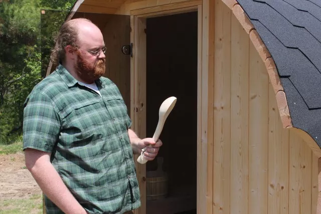 Glenn marvels over the wooden spoon he found in an outdoor steam room.