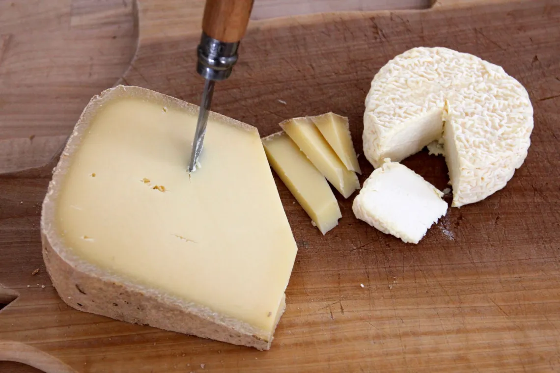A cutting board with a sampling of of the cheeses made by Sugar House Creamery in Upper Jay, New York