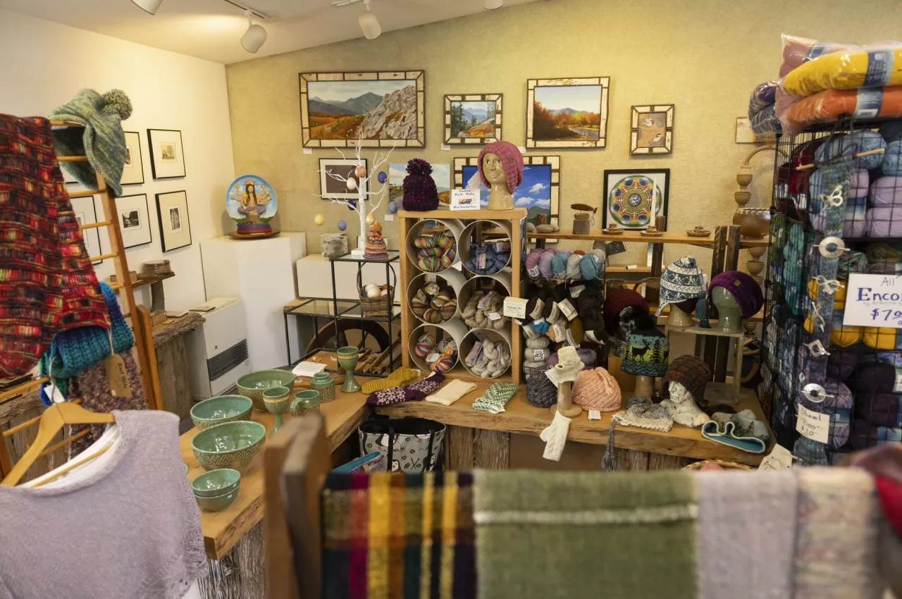 A filled art studio with an assortment of crafts for sale.