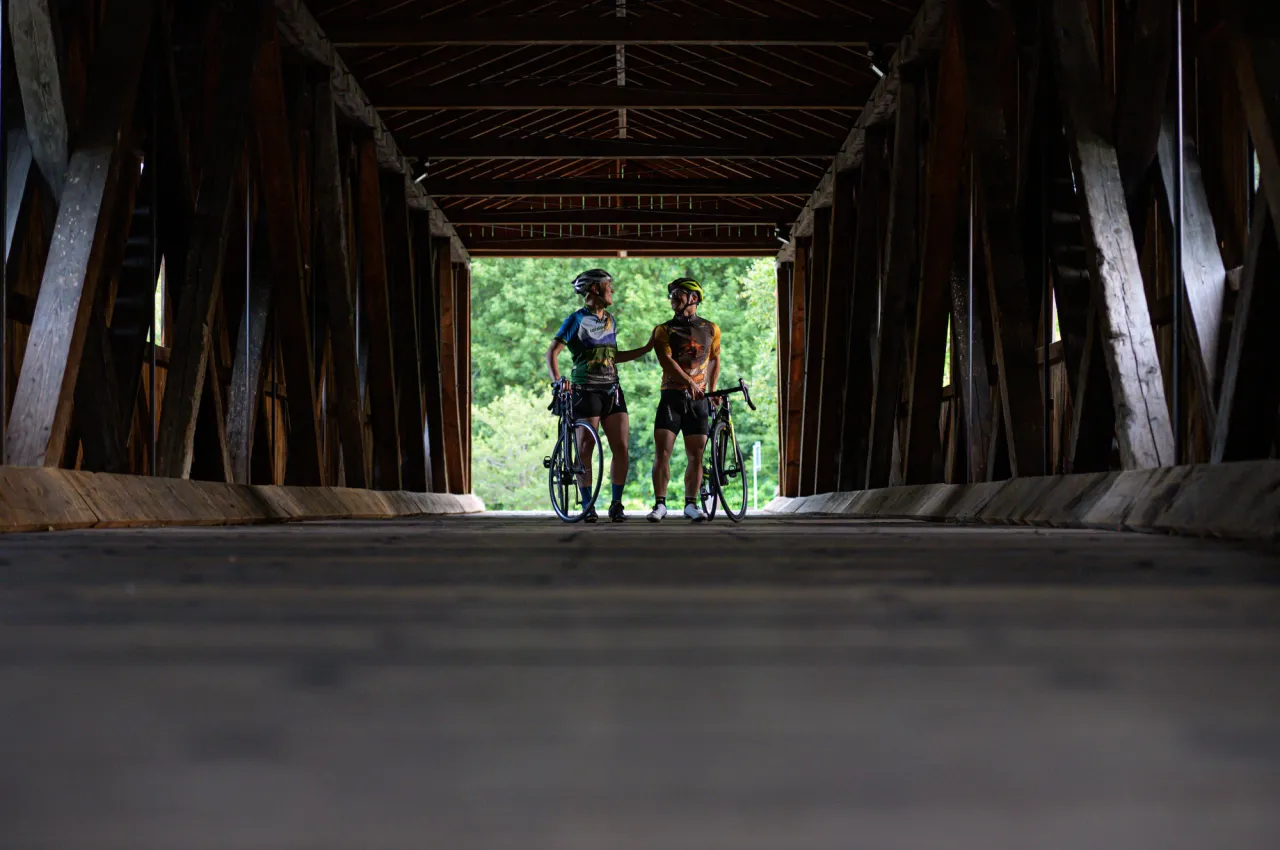 Cycling under a bridge.