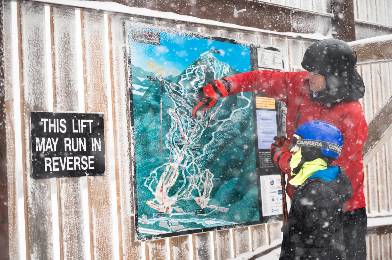 People looking at a trail map at Whiteface.