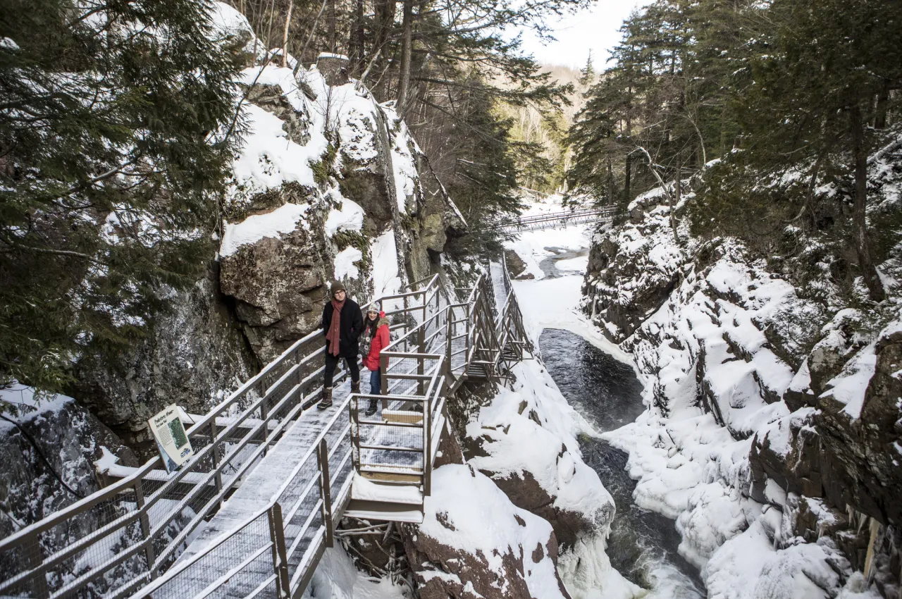 A couple exploring High Falls Gorge in the winter.