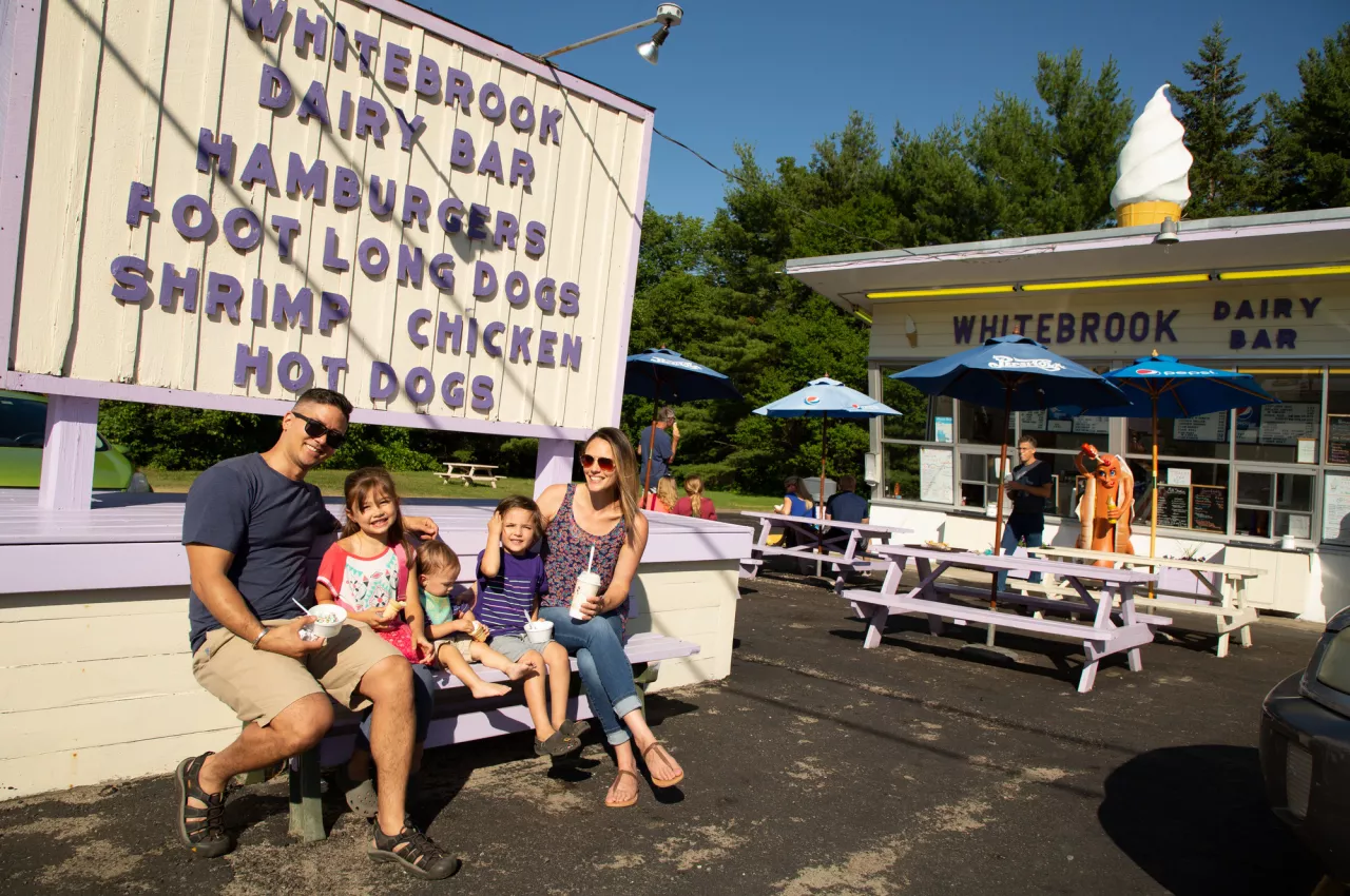 A family enjoys ice cream in front of Whitebrook Dairy Bar