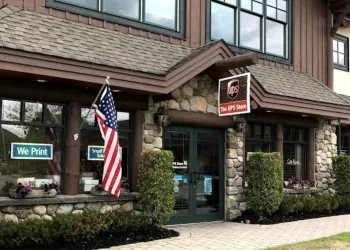 Exterior of the UPS store showing smooth sidewalks and nice green hedging.