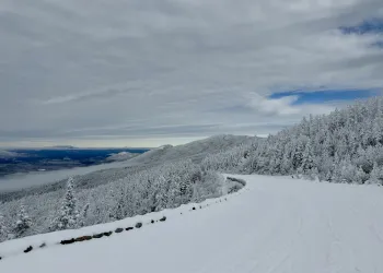 Looking down a mountain road covered in snow.