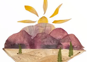 Leaves and natural materials arranged into a landscape view with a sun setting over the mountains.