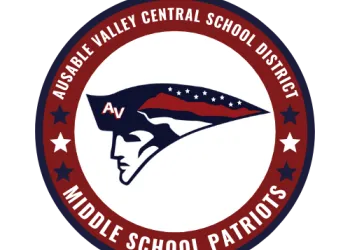 A circular badge with a profile of a man with a colonial hat that is striped red