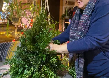 A person creates a boxwood tree at The Garden Inn Jay