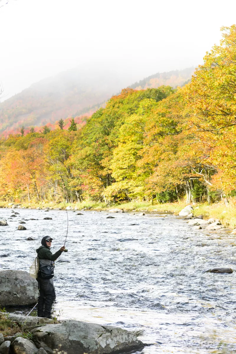 A fly fisherman casts a line in the Ausable River