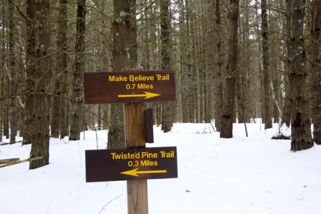 Trail sign showing the way to the "Make Believe" trail
