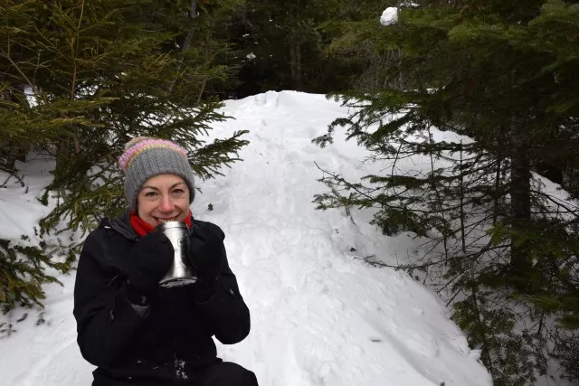 Anna warms up with some hot soup on Mount Van Hoevenberg.