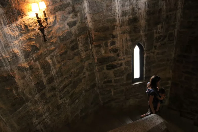 Rock walls, rock stairs, narrow windows, and a candle light glow — yep, it's a castle!