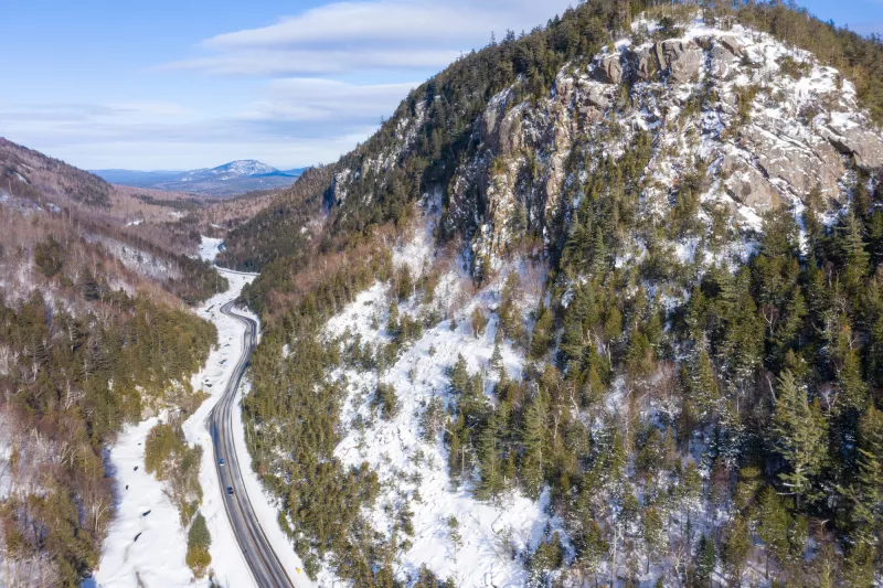 Snow-covered rocky mountains in the long, narrow valley of the Wilmington Notch.