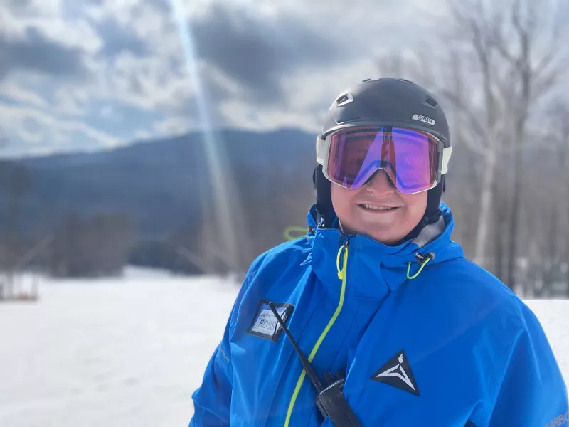 A smiling ski instructor during is morning lesson