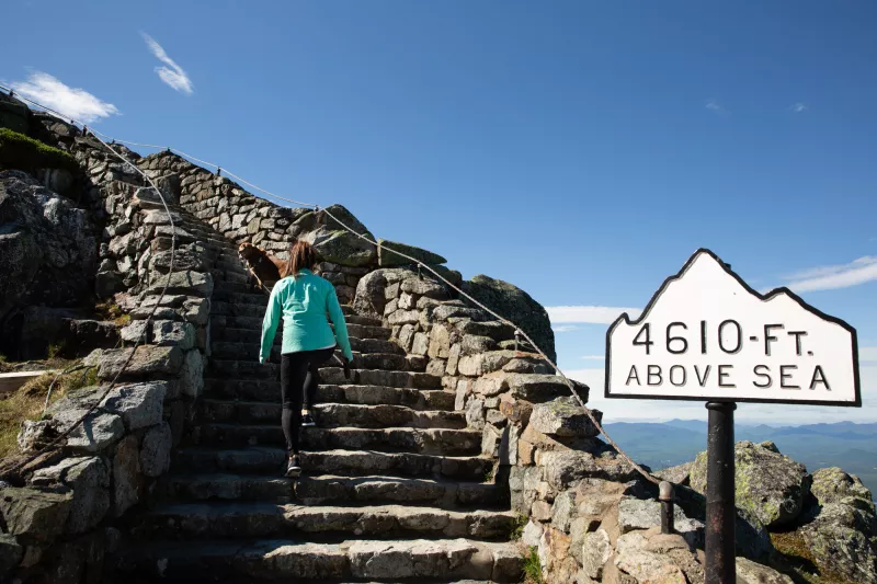 A hiker walks up the stairs to the Whiteface Summit