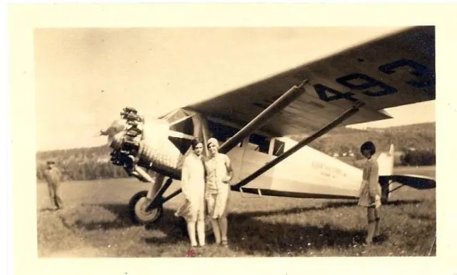 three people in front of a plane.