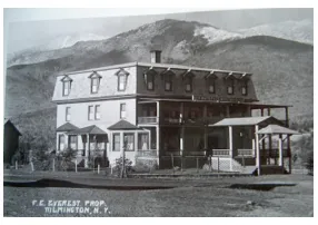 A square flat-top 1900's hotel in black and white.