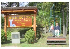 Wilmington Alpine events sign with vintage chairlift on the side.