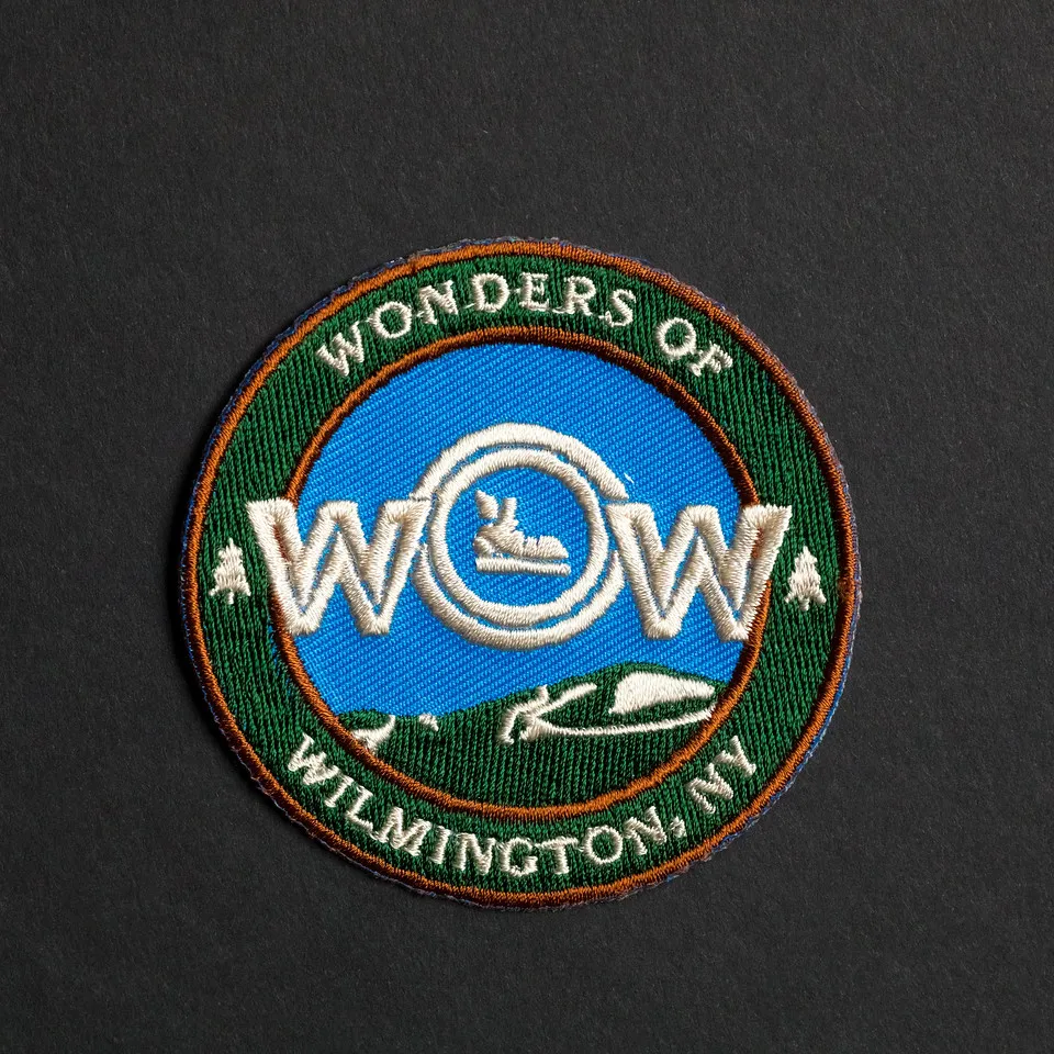 WOW hiking patch. Blue design with a hiking boot.