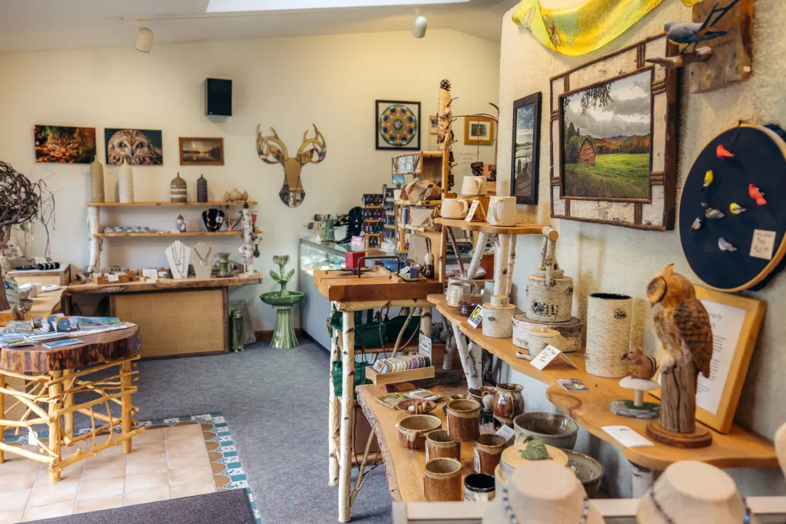 A display of pottery and adirondack gifts.